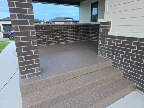 Covered front porch with textured concrete coating