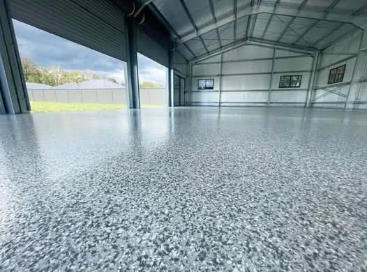 Grey flake epoxy floor in a large metal shop garage