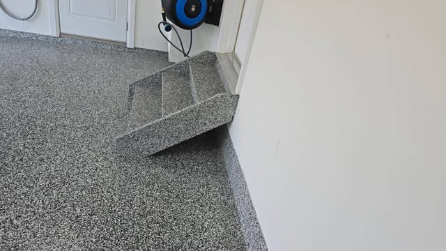 Coated garage floor with matching step nosing