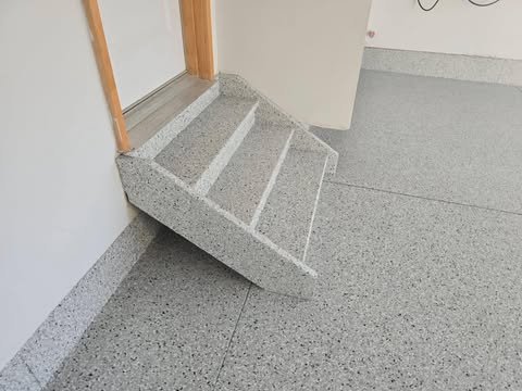 Light grey flake garage floor and coated threshold step